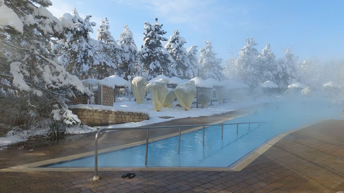 Aussenbecken in der Therme Geinberg, Landschaft ist tief verschneit.